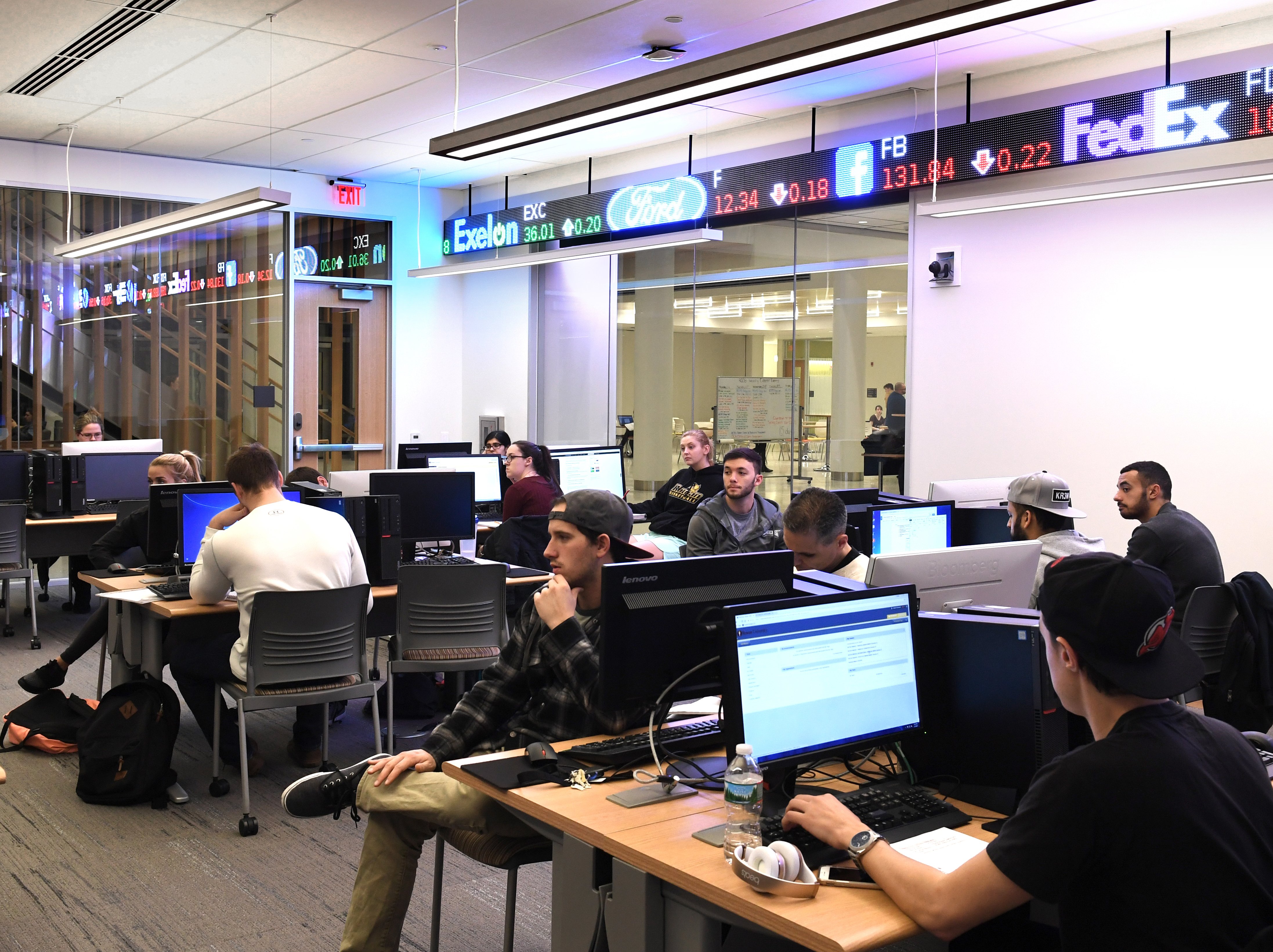 Class taking place in the trading room in business hall