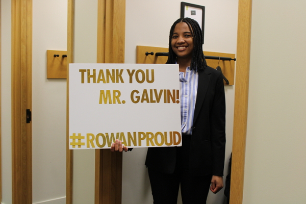 Student with thank you sign