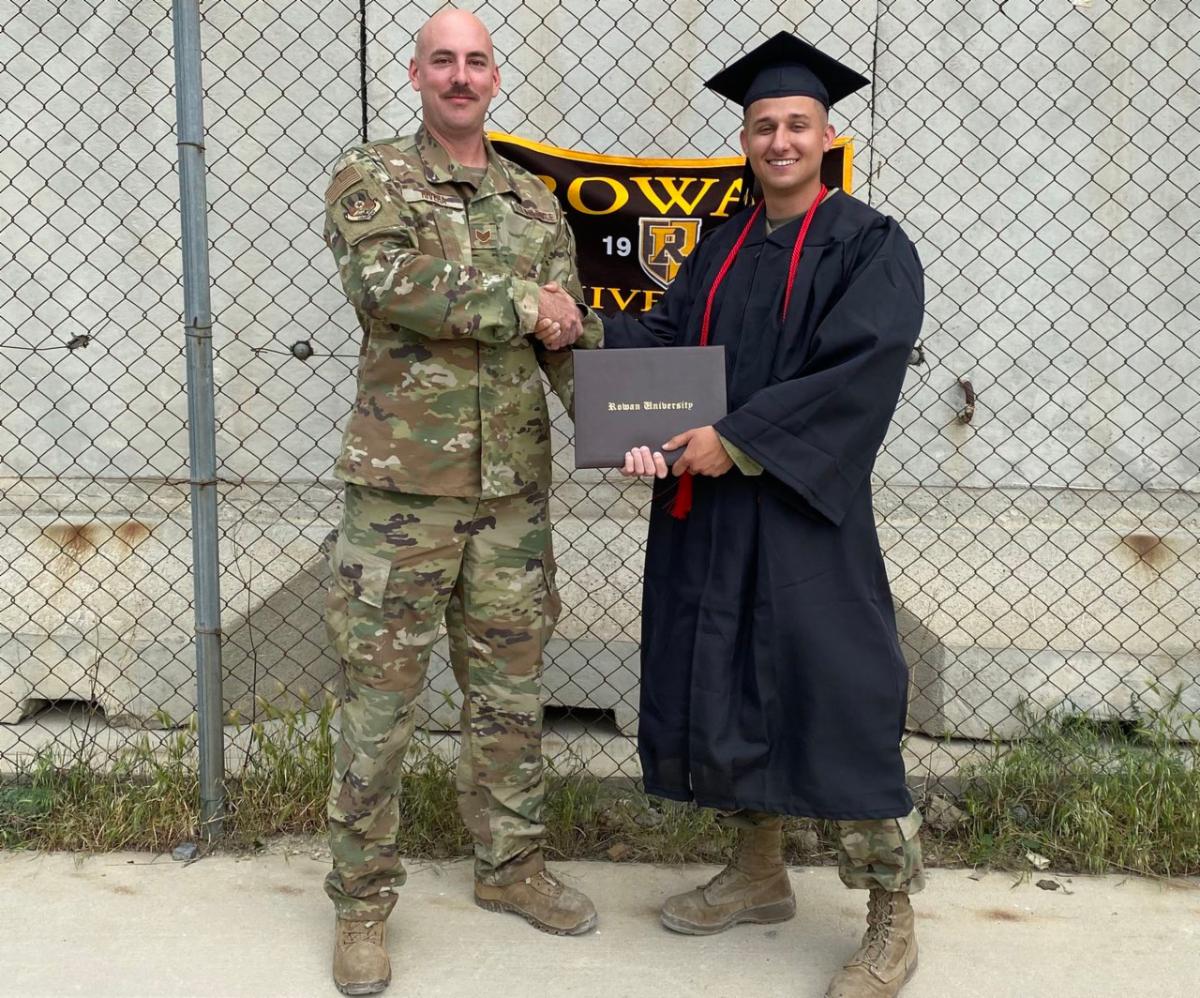 Brett Hopkins receives his diploma overseas