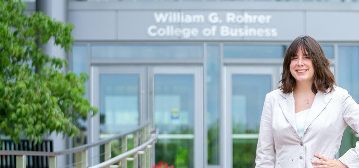 Student in front of Business Hall